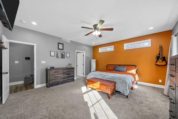 a bedroom with a bed and a chandelier