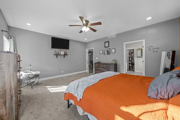 a bedroom with a bed and a flat screen tv