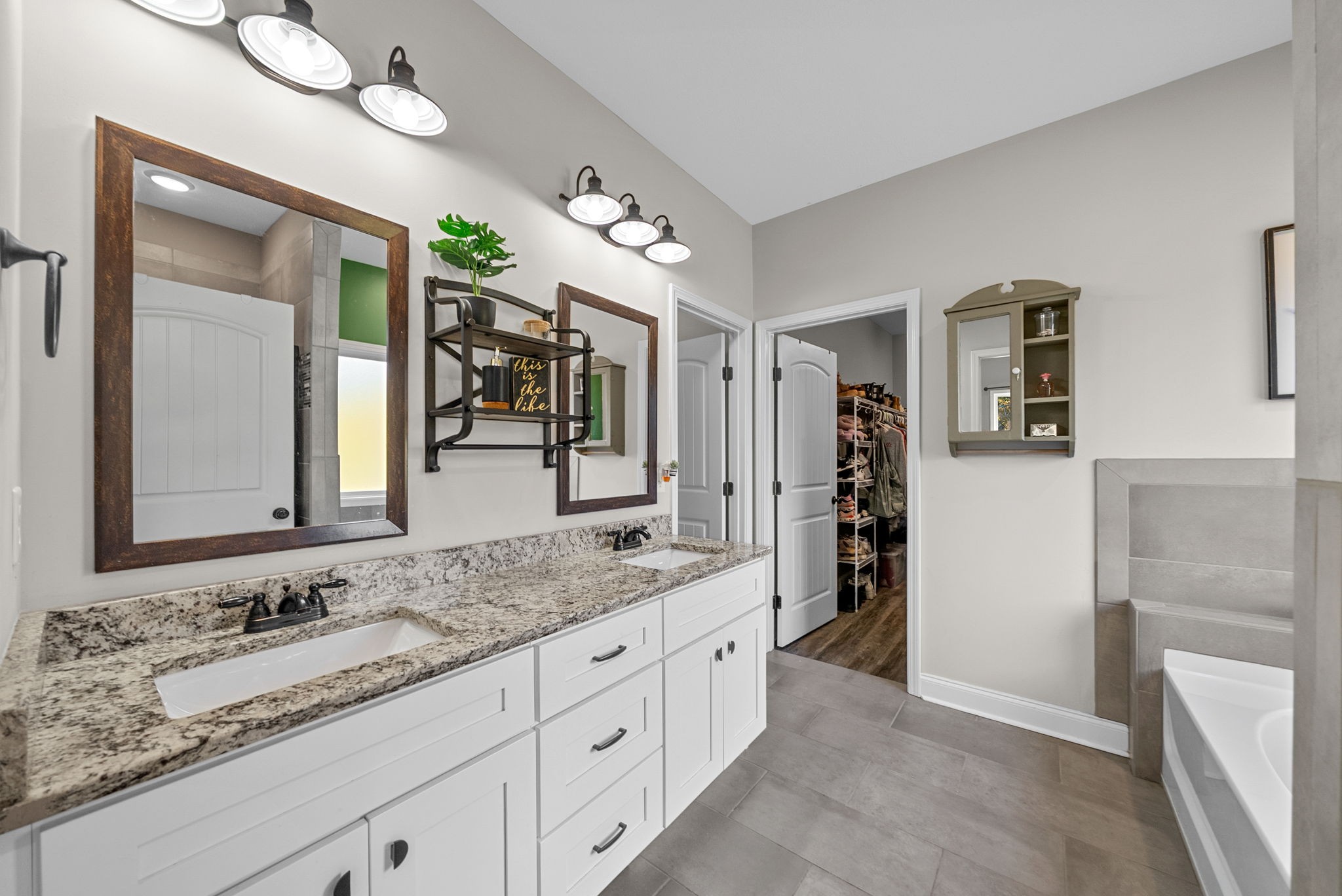 4553 Cumberland City Road Indian Mound, TN 37079 - Photo 20 of 44 a bathroom with a granite countertop double vanity sink and a mirror