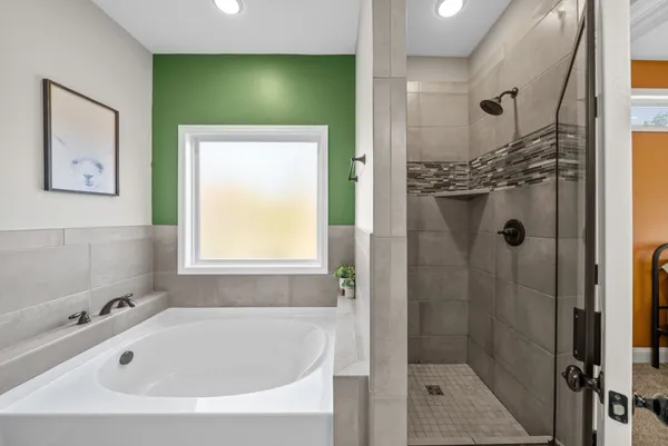 a bathroom with a tub and shower