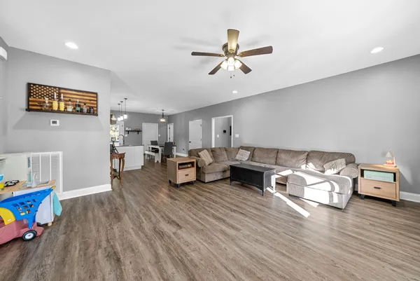 a living room with furniture and a wooden floor