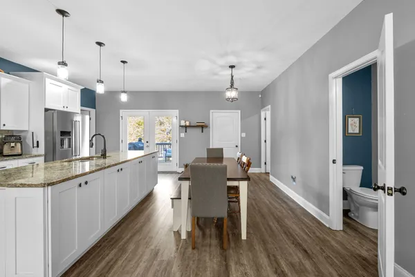 a large kitchen with a table and chairs