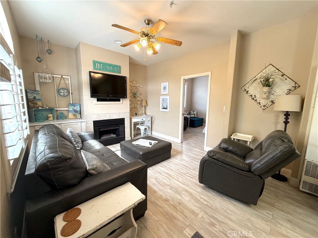 444 Pier Avenue, Unit 44 Oceano, CA 93445 - Photo 2 of 17 a living room with furniture a flat screen tv and a fireplace