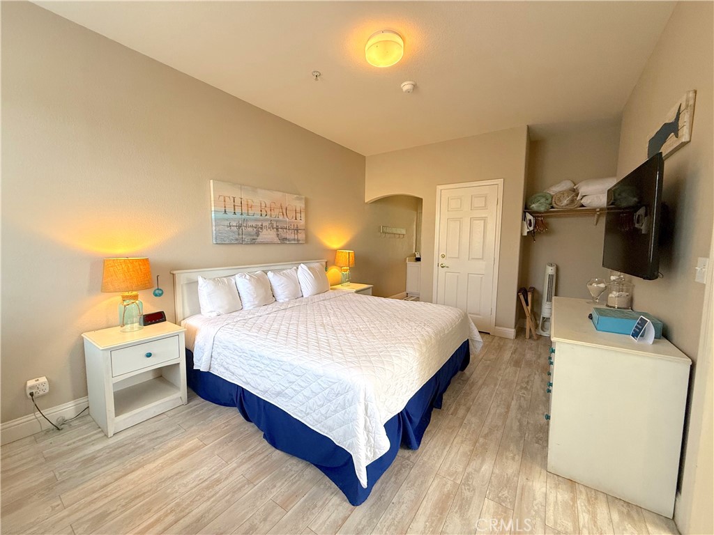 444 Pier Avenue, Unit 44 Oceano, CA 93445 - Photo 8 of 17 a bedroom with a bed and a flat tv screen on dresser