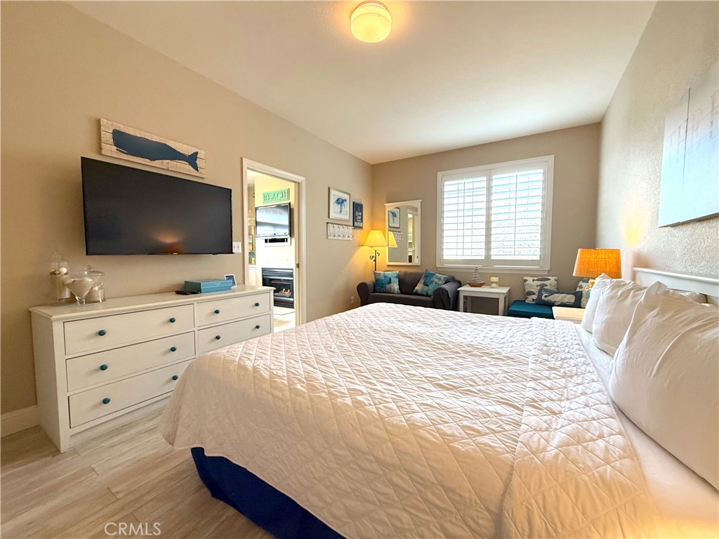 444 Pier Avenue, Unit 44 Oceano, CA 93445 - Photo 9 of 17 a bedroom with a bed and a flat screen tv