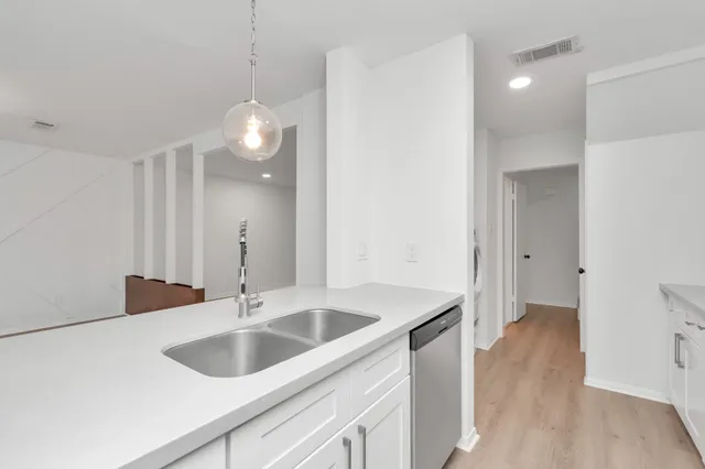 a kitchen with a sink and a refrigerator
