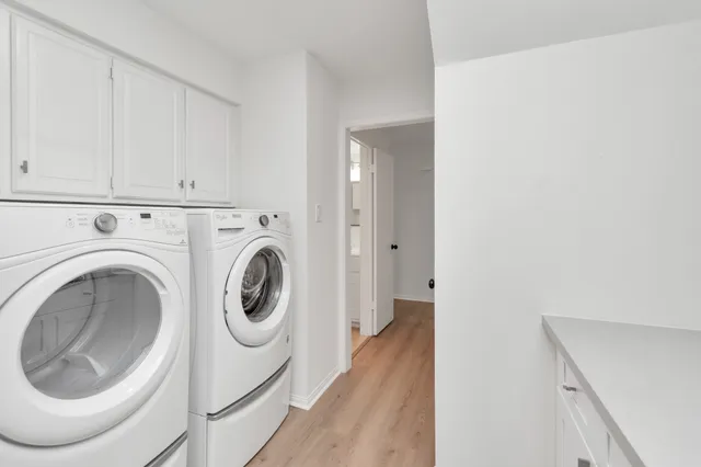 a view of a hallway with washer and dryer