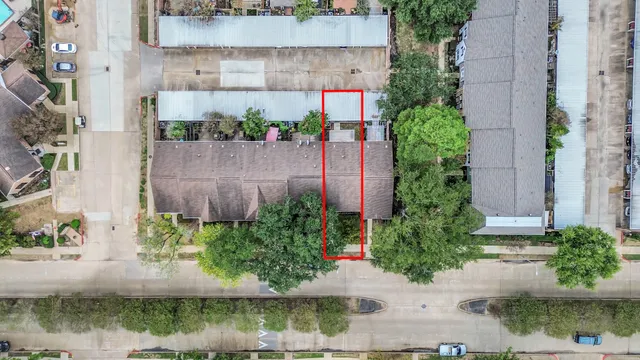 an aerial view of a house with a yard and a fountain