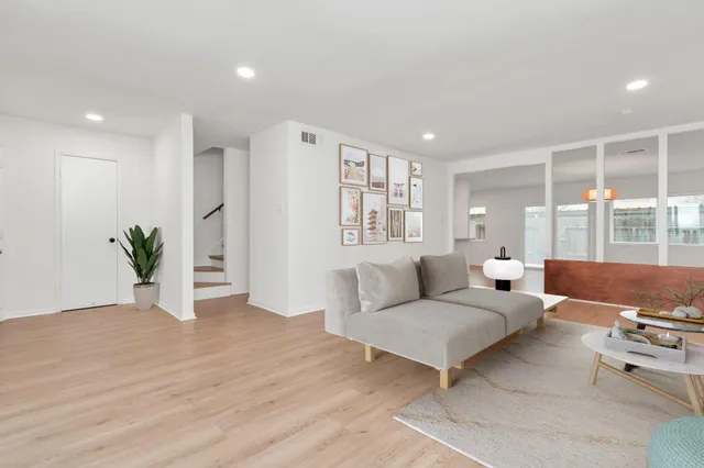 a living room with furniture and large windows