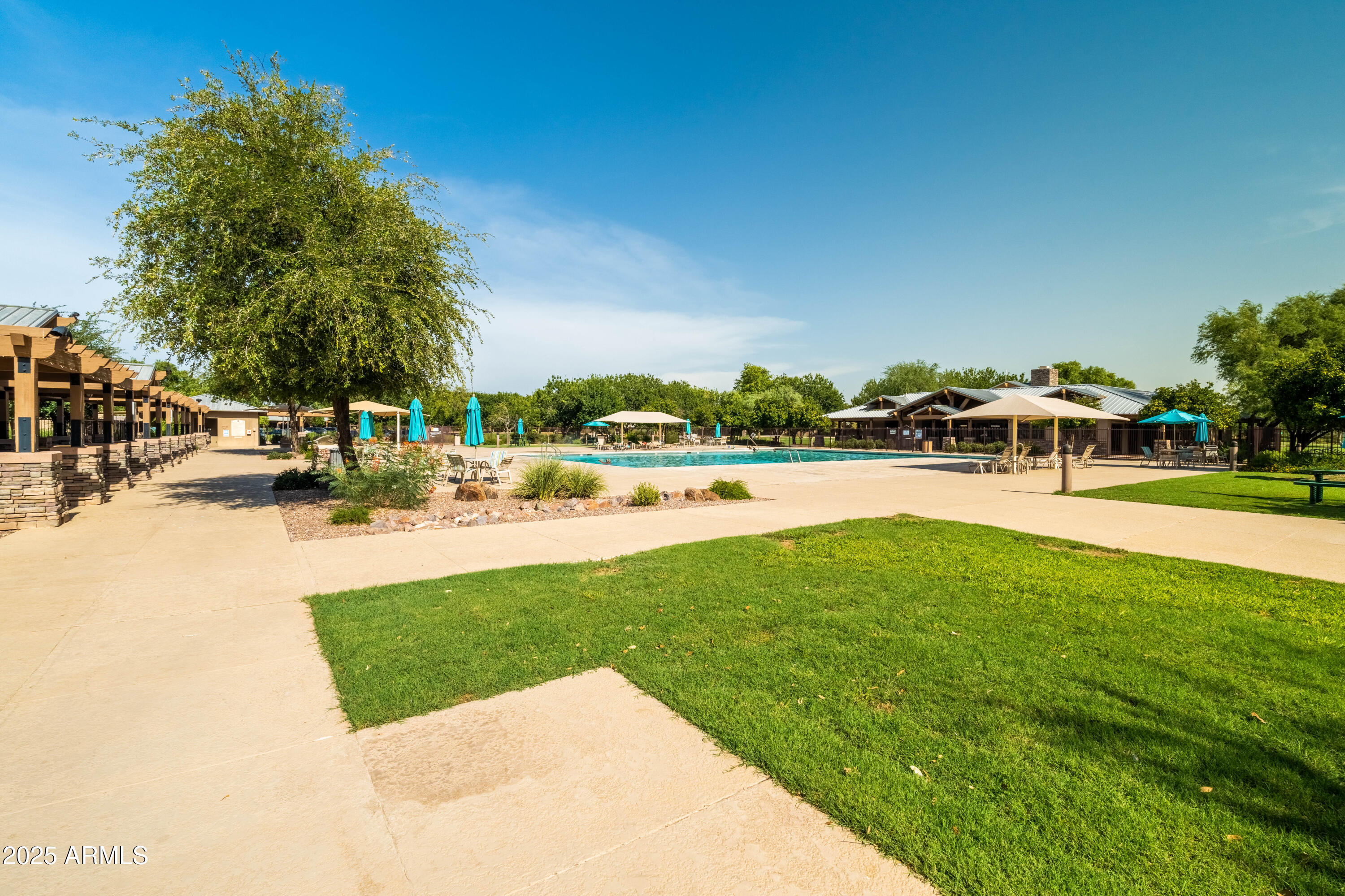 4140 East Claxton Avenue Gilbert, AZ 85297 - Photo 101 of 112 a view of swimming pool with outdoor seating and trees