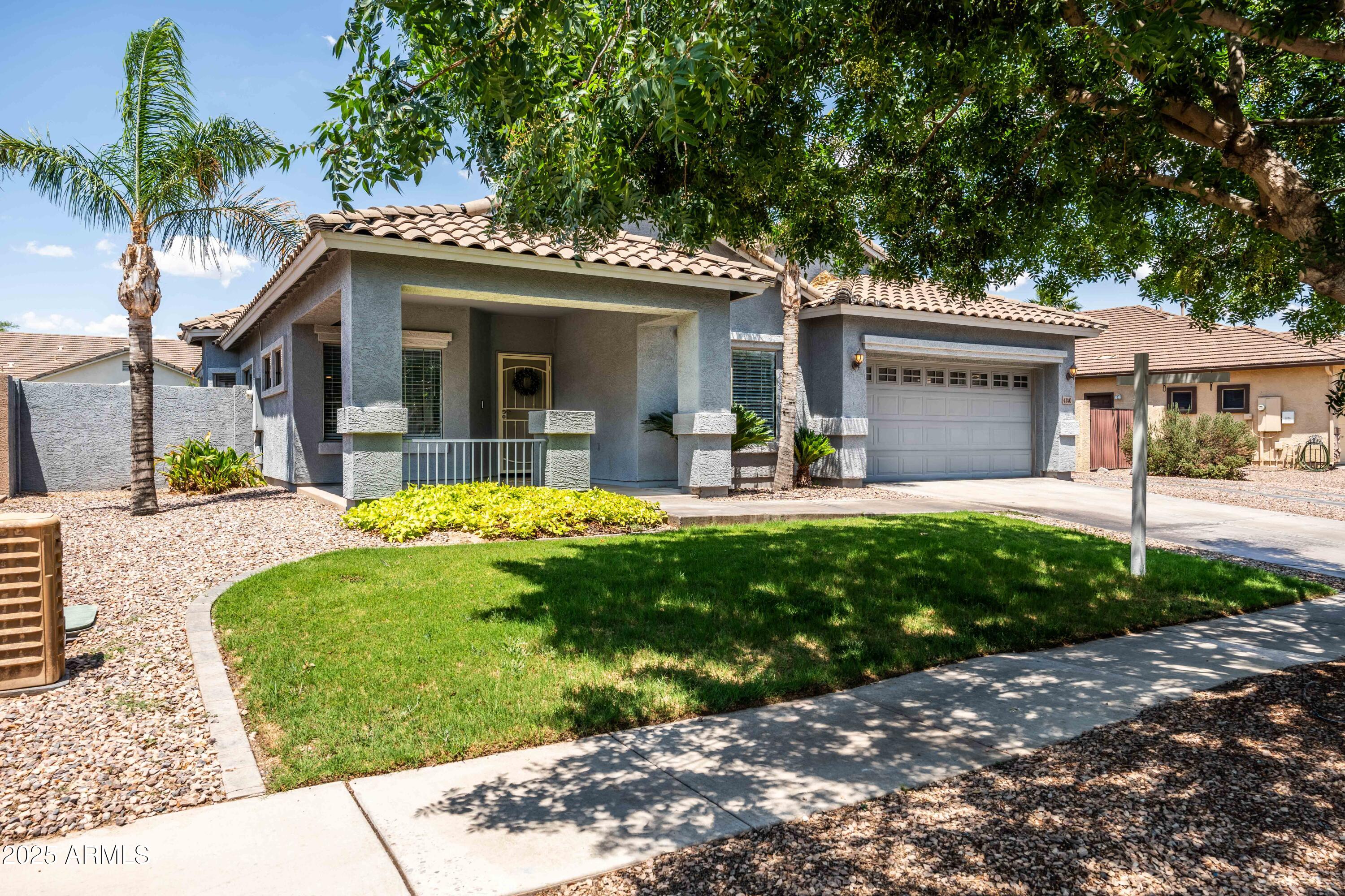4140 East Claxton Avenue Gilbert, AZ 85297 - Photo 11 of 112 a view of a house with a yard and potted plants
