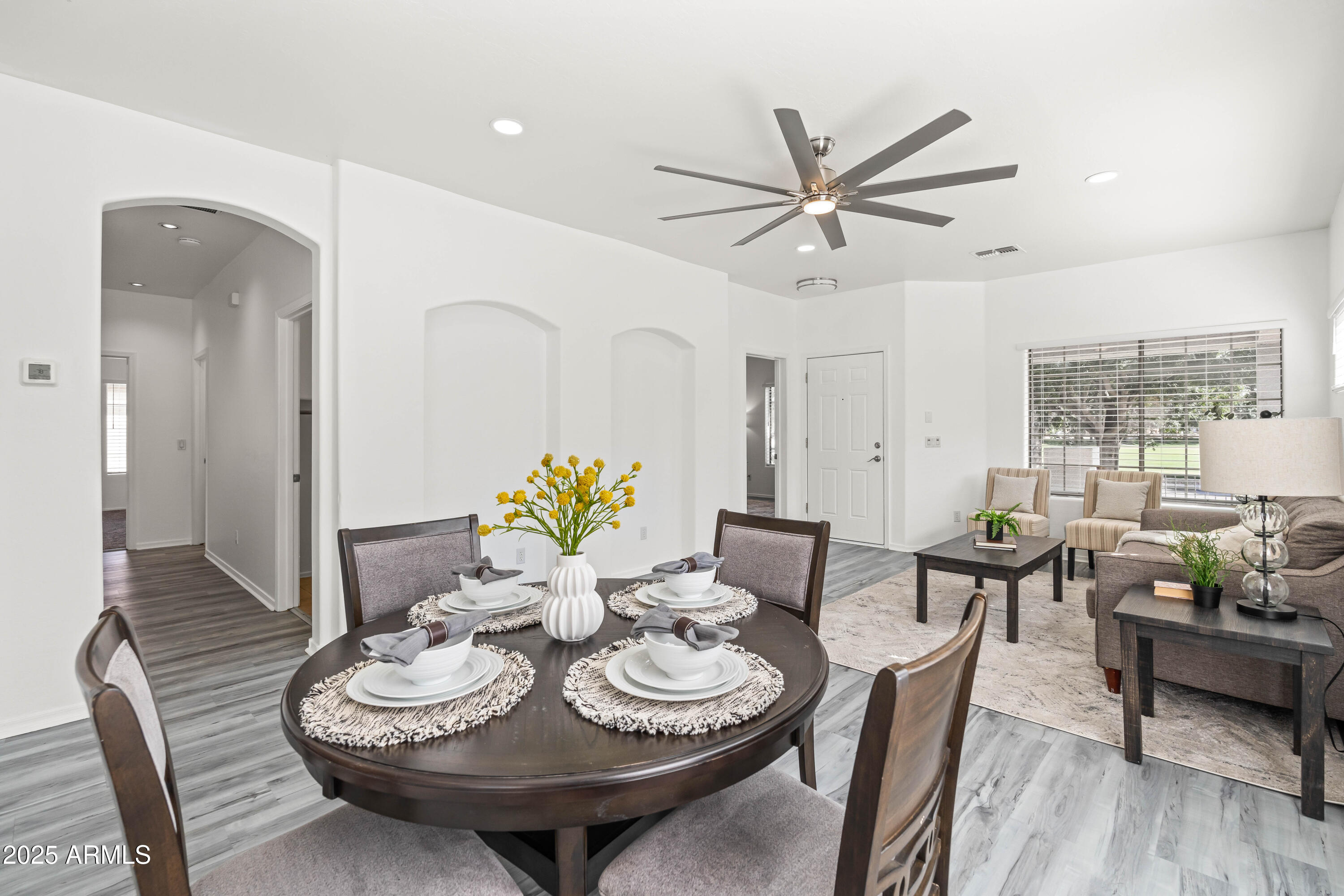 4140 East Claxton Avenue Gilbert, AZ 85297 - Photo 18 of 112 a view of a dining room with furniture and wooden floor