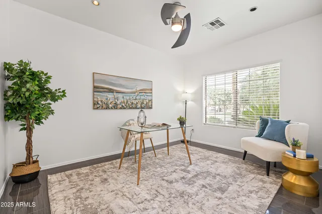 a living room with furniture a window and wooden floor