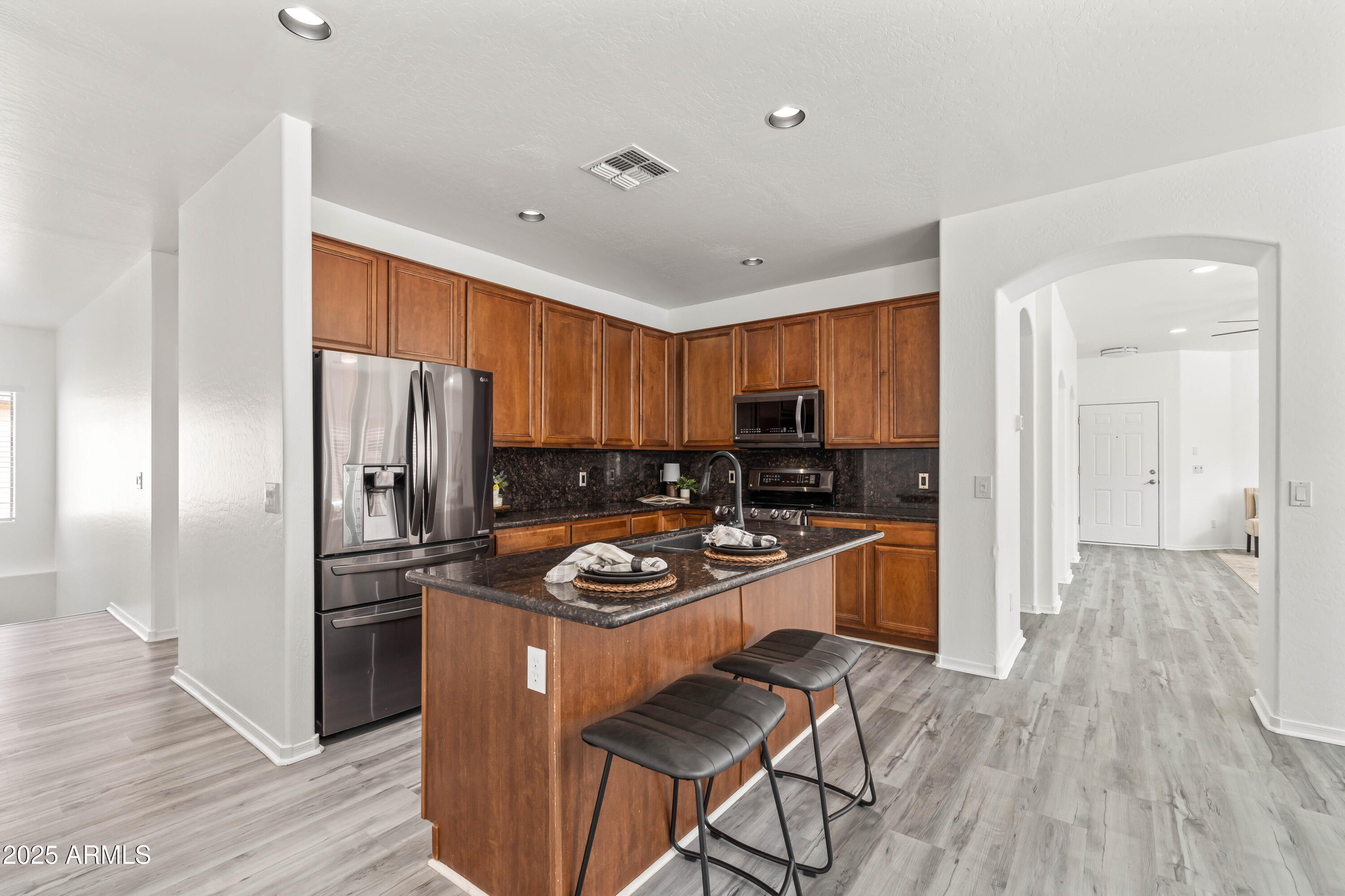 4140 East Claxton Avenue Gilbert, AZ 85297 - Photo 25 of 112 a kitchen with stainless steel appliances granite countertop a refrigerator stove and oven