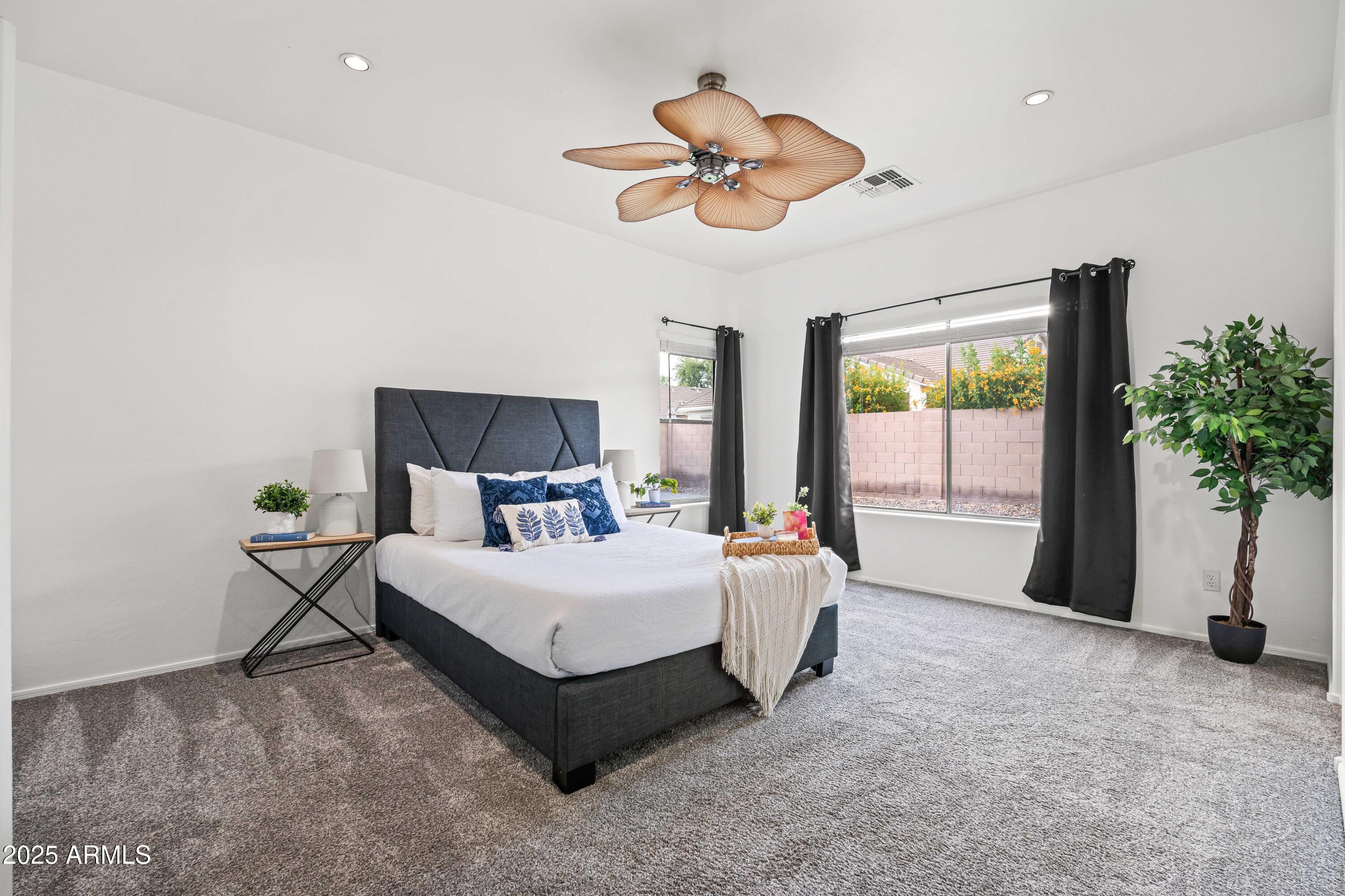 4140 East Claxton Avenue Gilbert, AZ 85297 - Photo 35 of 112 a bedroom with a bed chandelier and a window