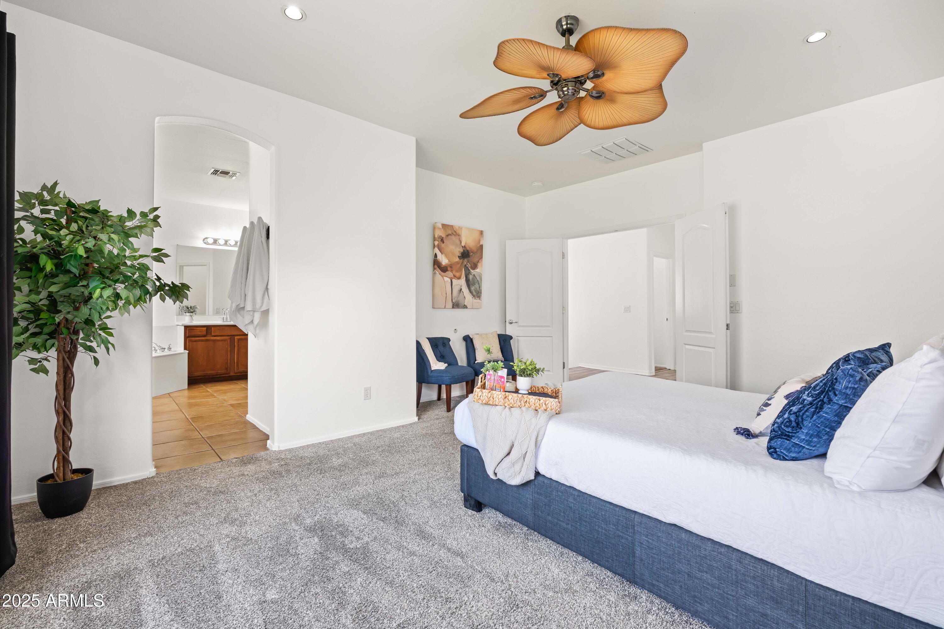 4140 East Claxton Avenue Gilbert, AZ 85297 - Photo 37 of 112 a bedroom with a bed and a potted plant