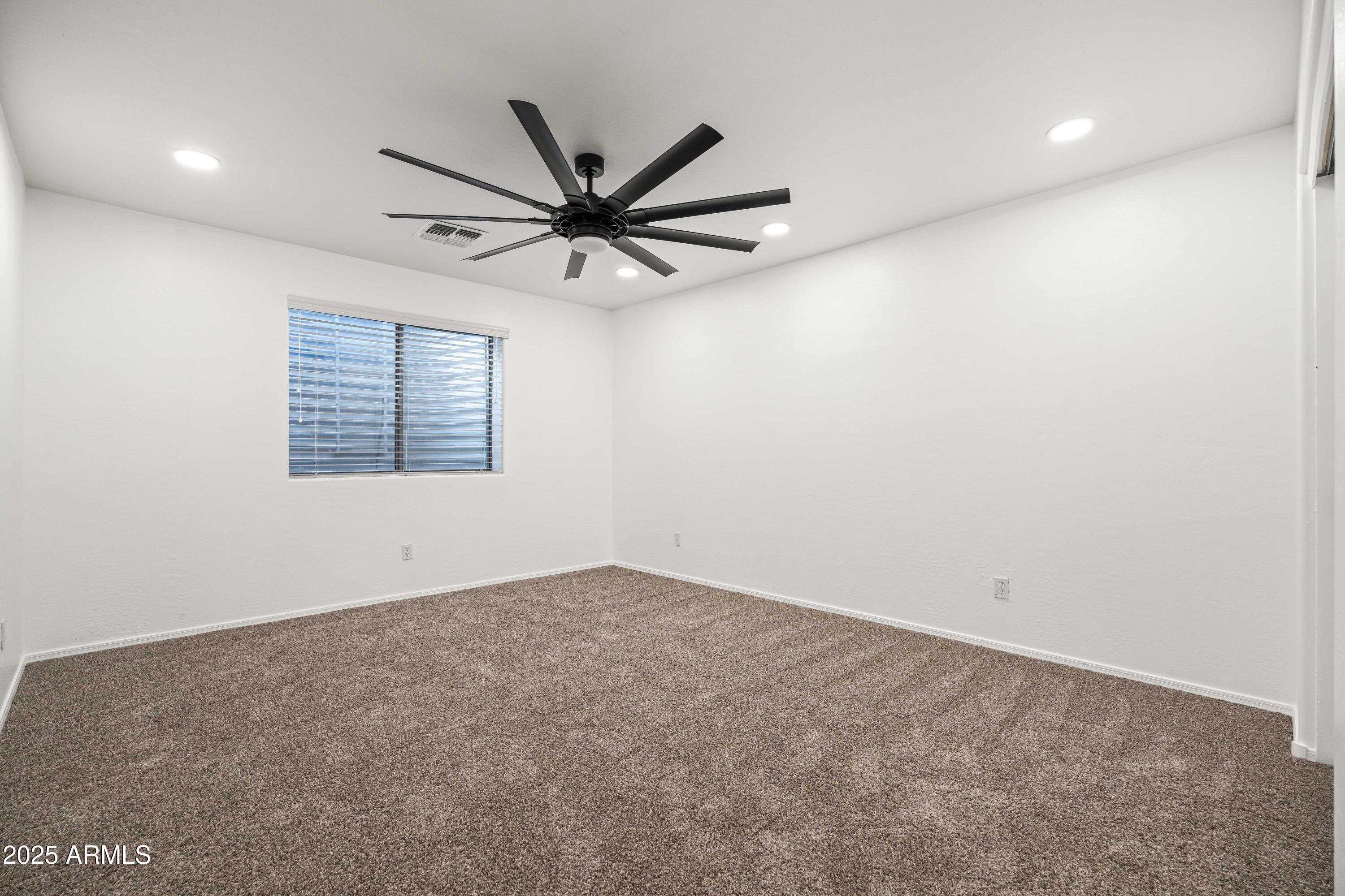 4140 East Claxton Avenue Gilbert, AZ 85297 - Photo 57 of 112 an empty room with a window and a fan