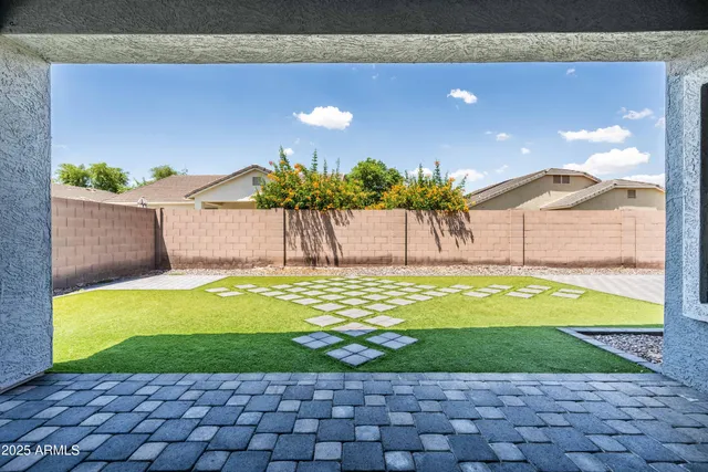 a view of a house with a yard and potted plants