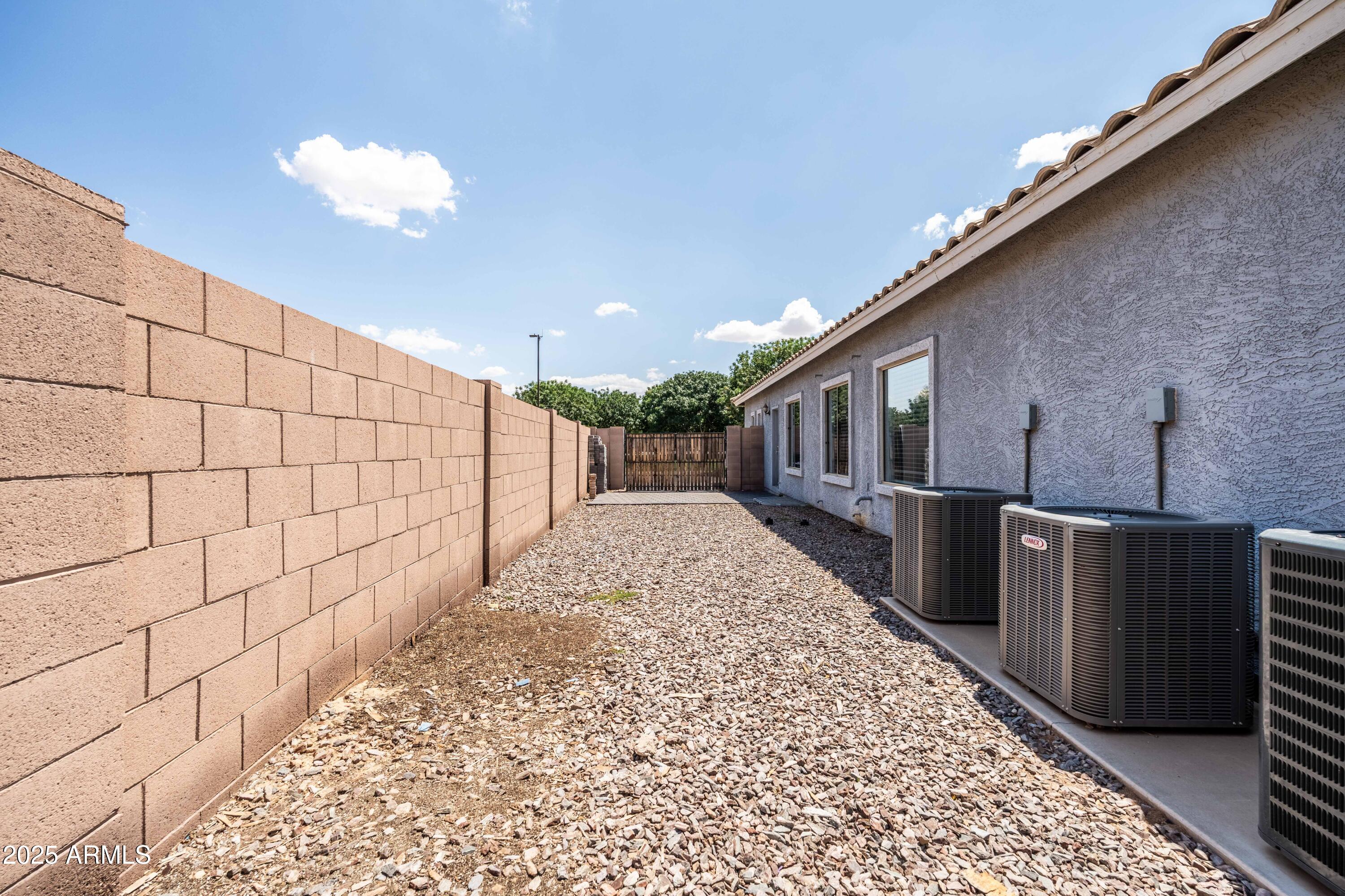 4140 East Claxton Avenue Gilbert, AZ 85297 - Photo 77 of 117 a view of a backyard with wooden fence