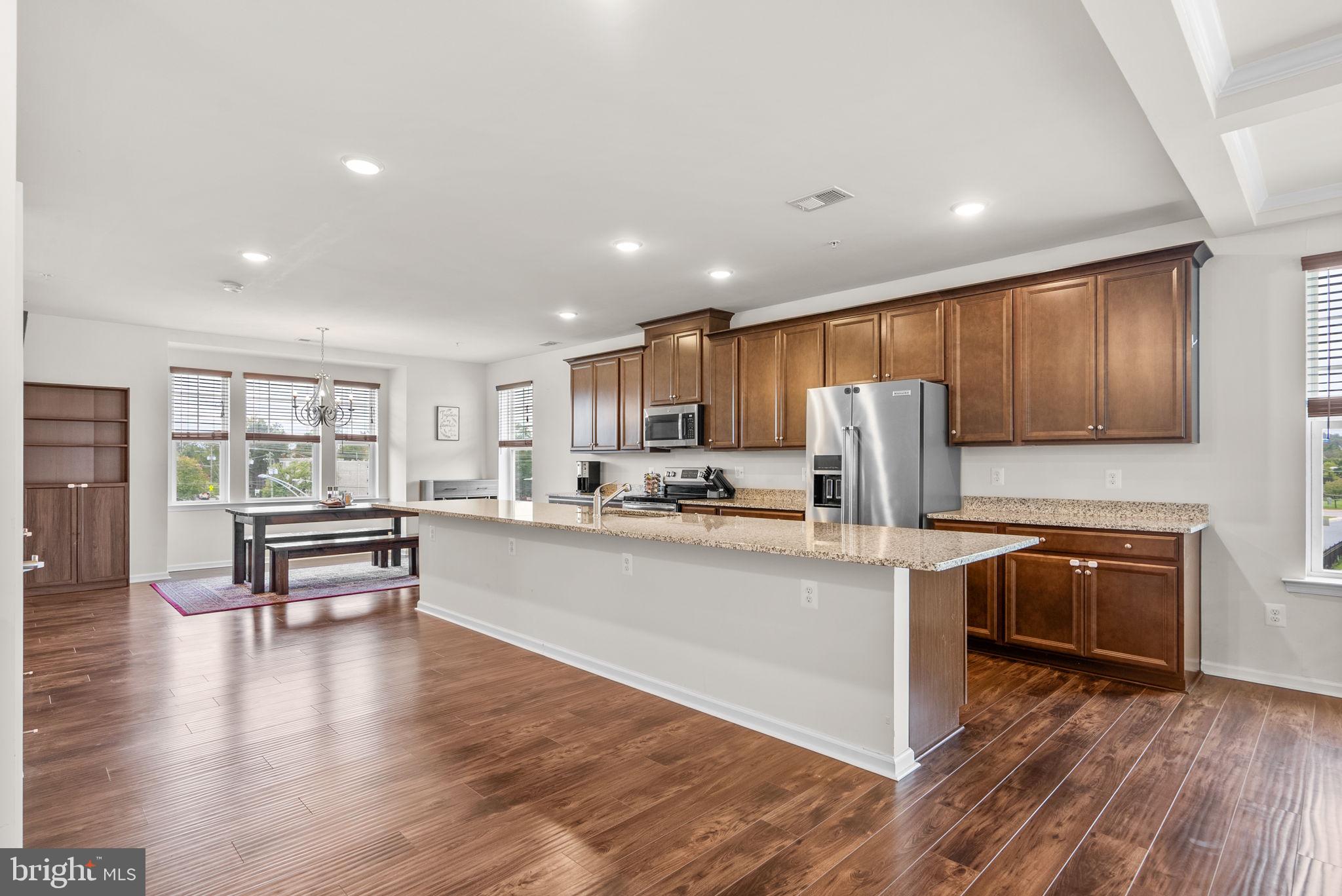 2701 Pinebrook Road Hyattsville, MD 20785 - Photo 9 of 27 a kitchen with stainless steel appliances a stove a sink a refrigerator cabinets and wooden floor