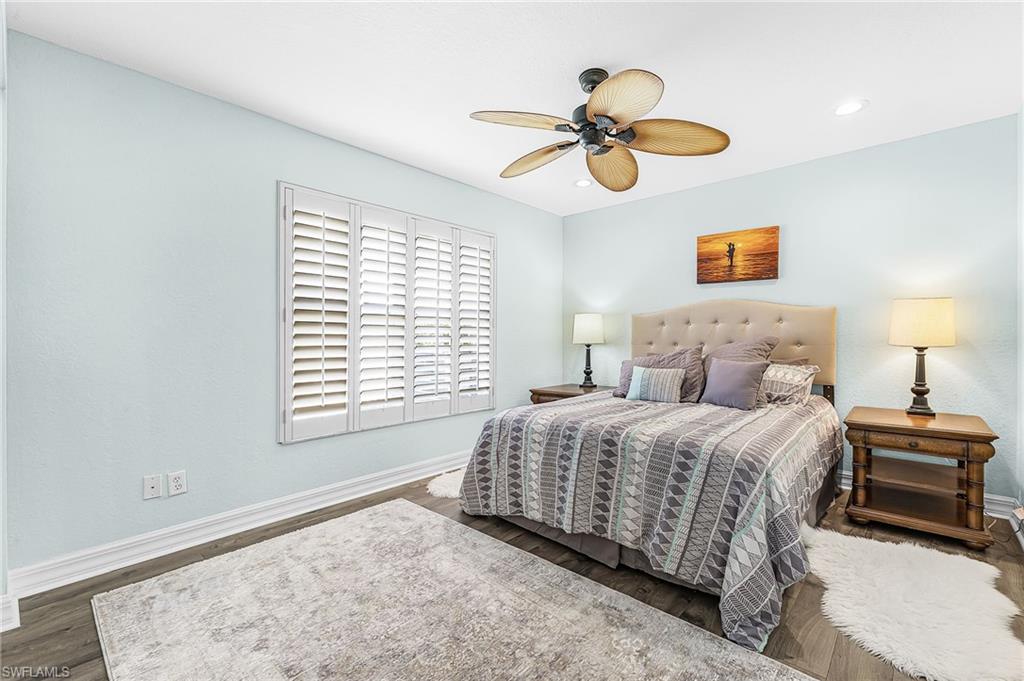 1415 Princess Sabal Point Naples, FL 34119 - Photo 13 of 42 Wood-finish flooring with light-colored walls, white plantation shutters, and a ceiling fan