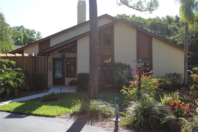 a couple of flower plants in front of house