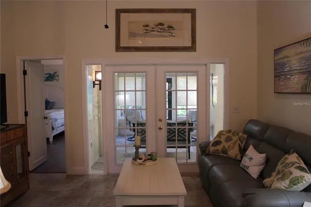 a living room with furniture and a painting on the wall