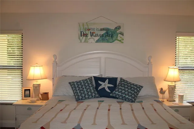 a bedroom with a bed and a night stand