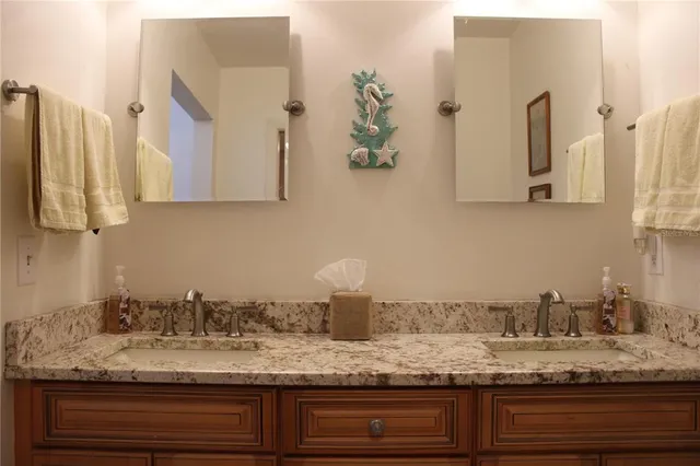 a bedroom with a bed and a mirror