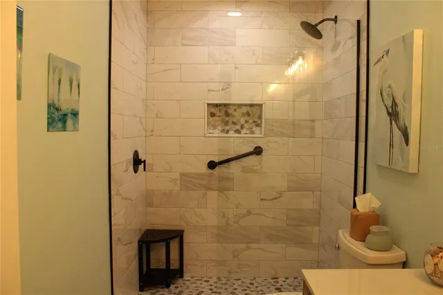 a bedroom with a bed a mirror and a window