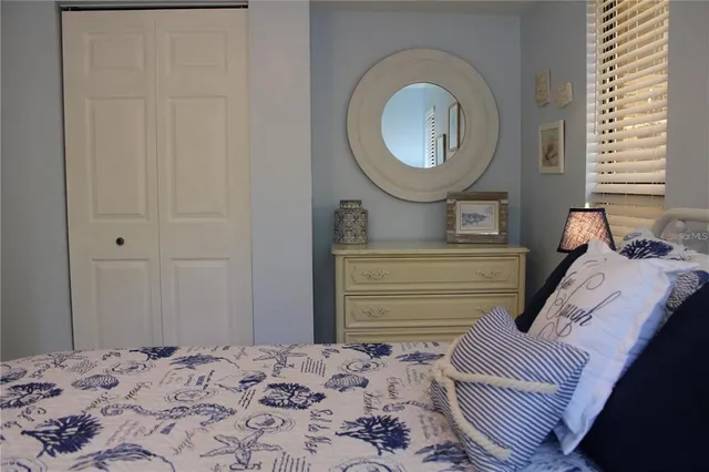 a view of a workspace room with furniture and a window