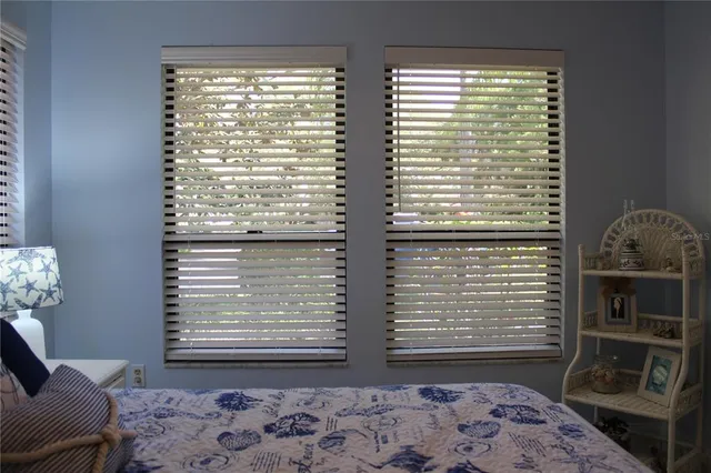 a living room with furniture and floor to ceiling window