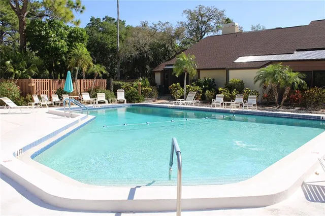 a view of a patio with a dining table and chairs with a fire pit