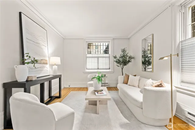 a living room with furniture fireplace and a window