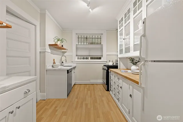 a kitchen with sink cabinets and window
