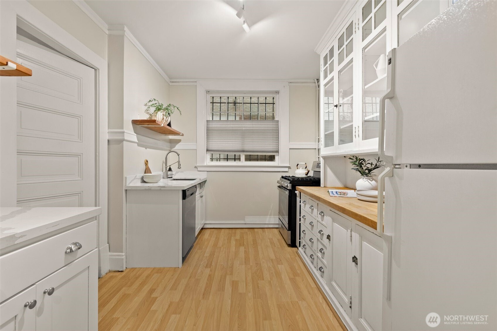 615 Boren Avenue, Unit 6 Seattle, WA 98104 - Photo 8 of 26 a kitchen with sink cabinets and window