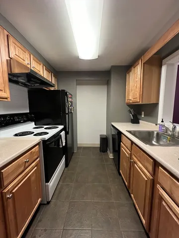 a kitchen with stainless steel appliances a stove sink and microwave