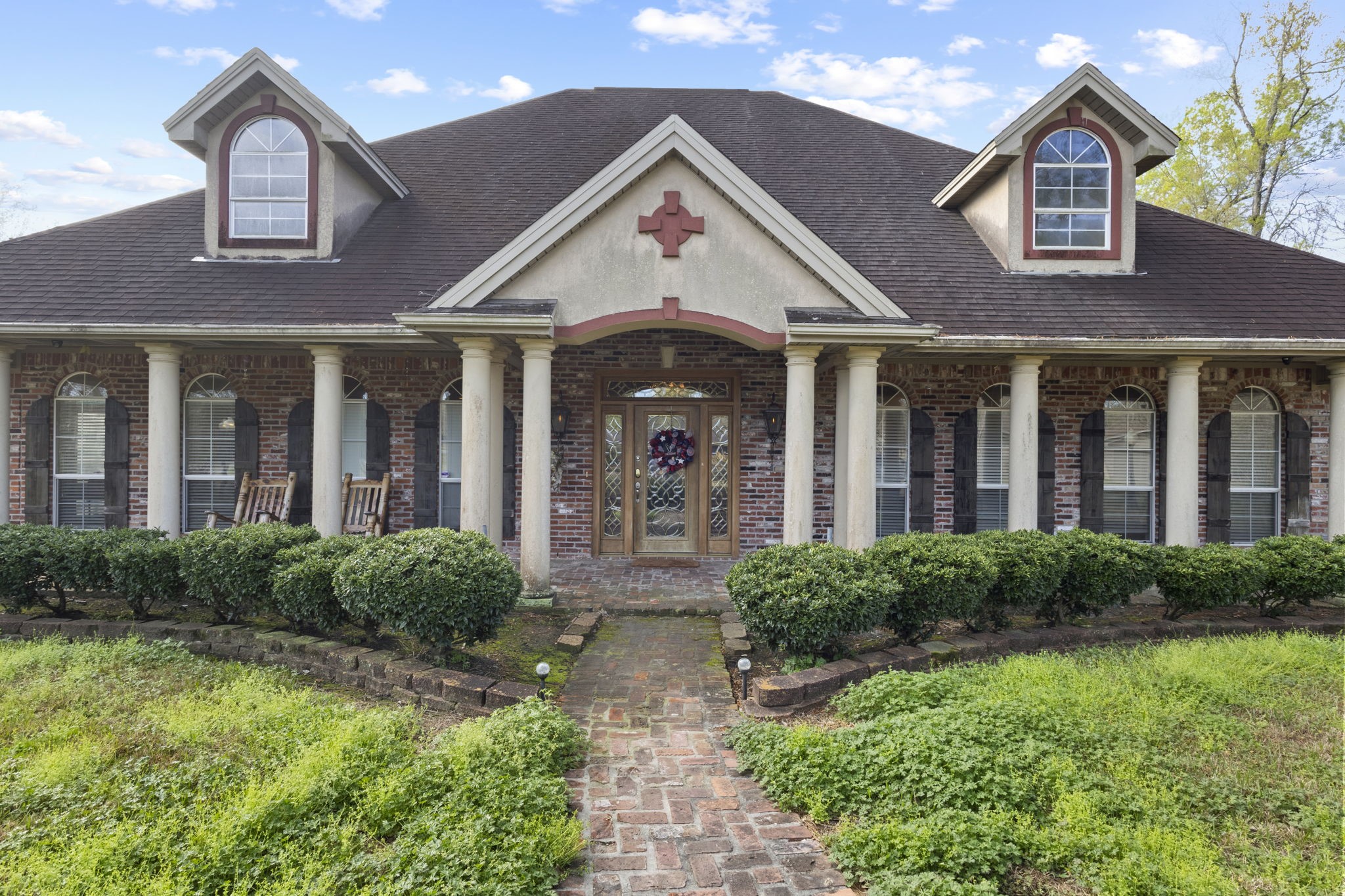 a front view of a house with garden