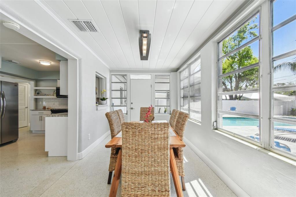 827 Virginia Street Dunedin, FL 34698 - Photo 18 of 46 a living room with furniture a large window and kitchen view