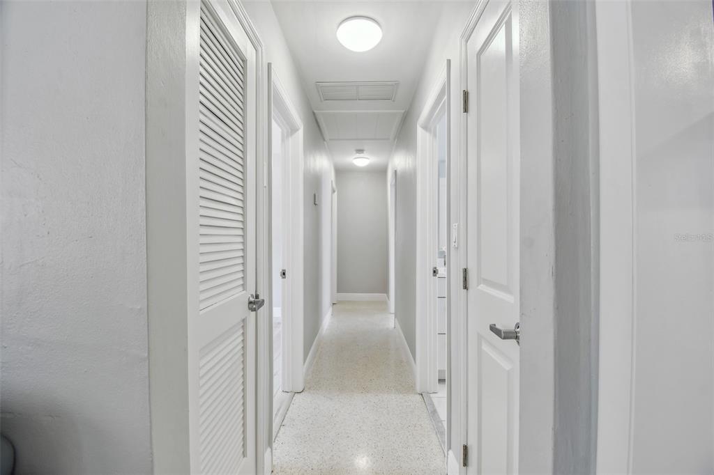 827 Virginia Street Dunedin, FL 34698 - Photo 30 of 46 a view of a hallway with wooden floor and a bathroom