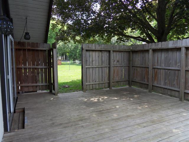 60 Briarcliff Road Montgomery, IL 60538 - Photo 8 of 25 a view of a backyard with wooden fence and large trees