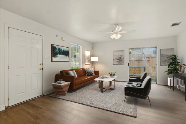 a living room with furniture and wooden floor