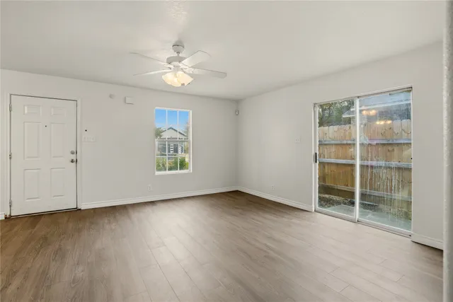 wooden floor in an empty room with a window