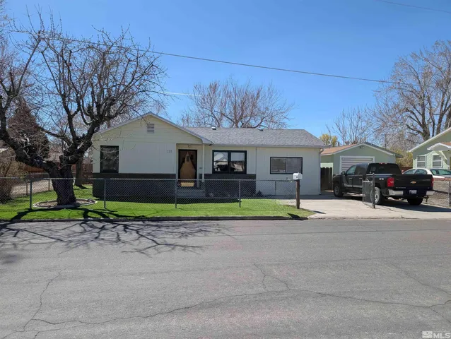 a view of street along with house and trees