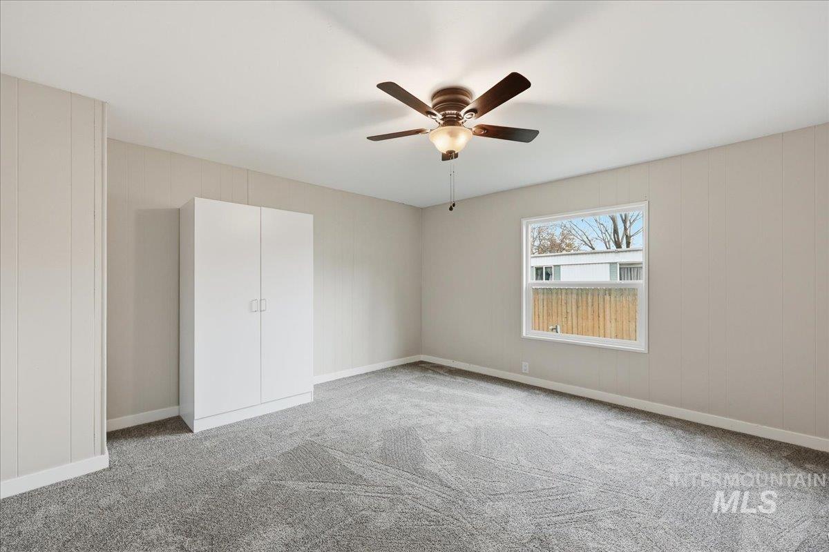 445 South Maple Grove Road, Unit 15 Boise, ID 83709 - Photo 13 of 20 Unfurnished bedroom with light carpet and a ceiling fan