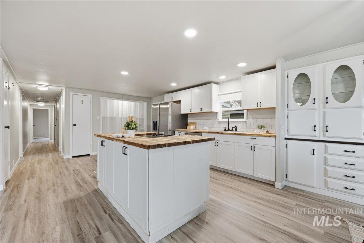 445 South Maple Grove Road, Unit 15 Boise, ID 83709 - Photo 5 of 20 Kitchen featuring white cabinetry, a center island, butcher block countertops, stainless steel fridge with ice dispenser, and recessed lighting