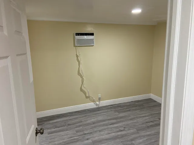 a view of a room with wooden floor