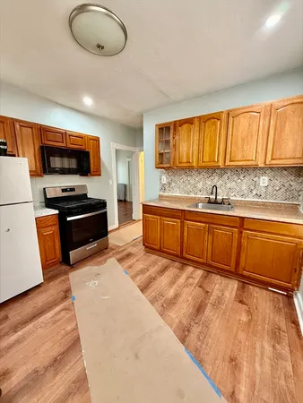 a kitchen with stainless steel appliances granite countertop a sink and a stove