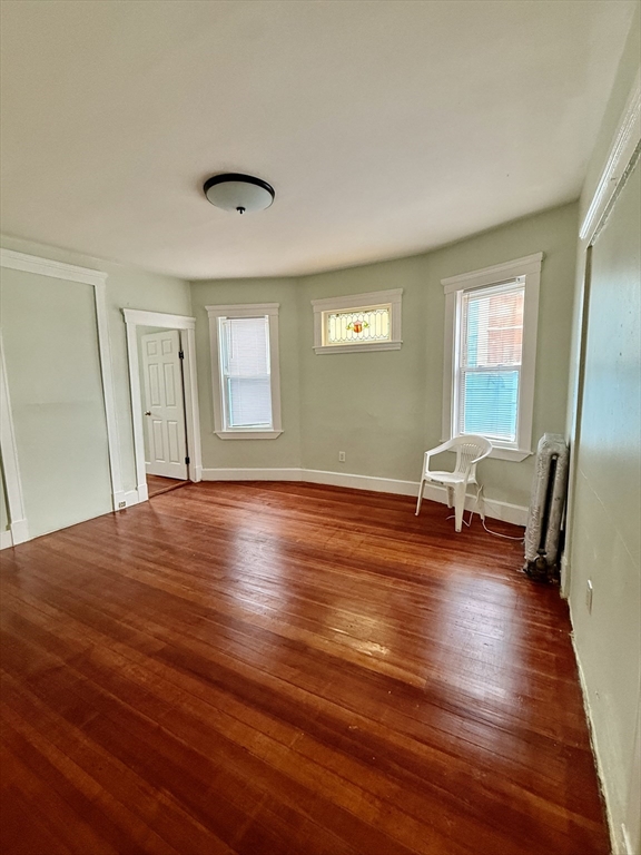 15 Dunlap Street, Unit 2 Boston, MA 02124 - Photo 3 of 8 a view of empty room with wooden floor and fan
