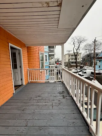 a view of a porch with wooden floor